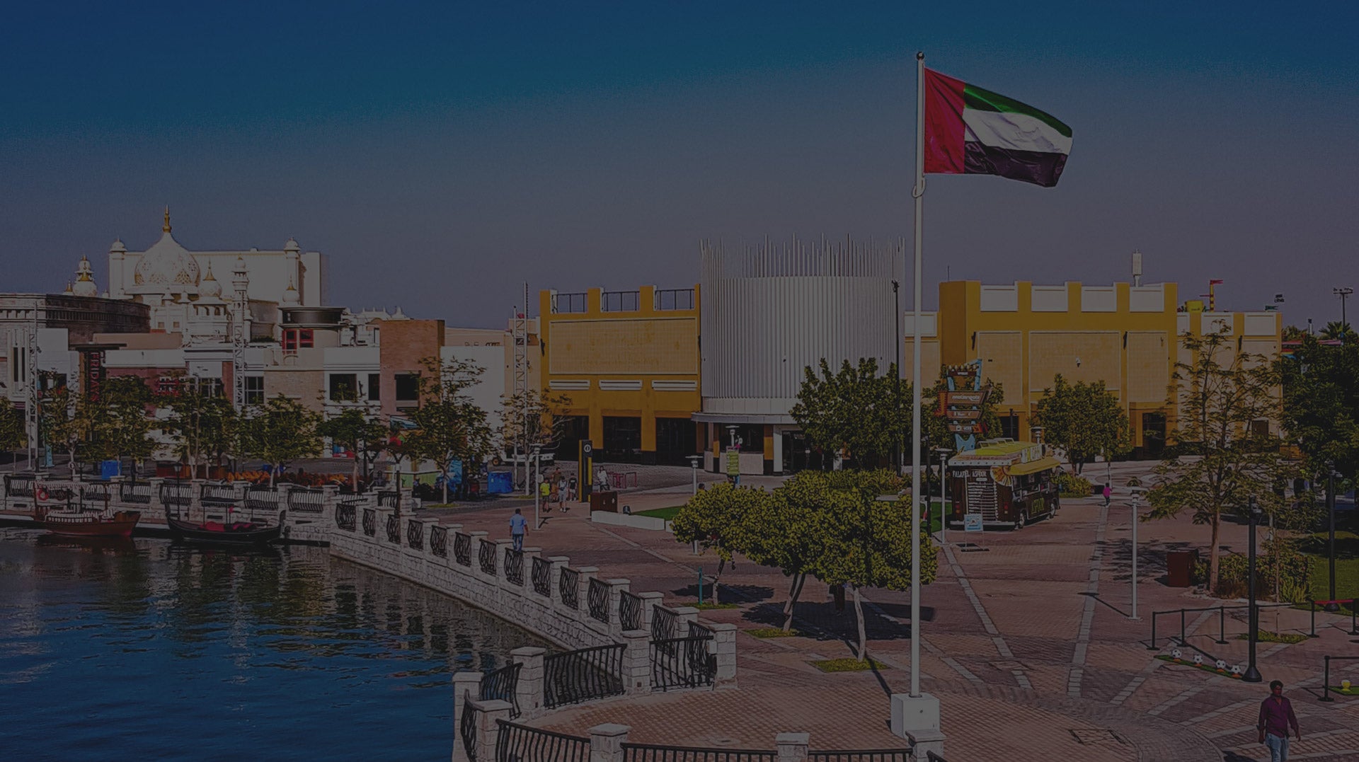 A close-up of the UAE flag mounted on a vehicle safety flag pole, used to enhance visibility and signify national identity in various settings.