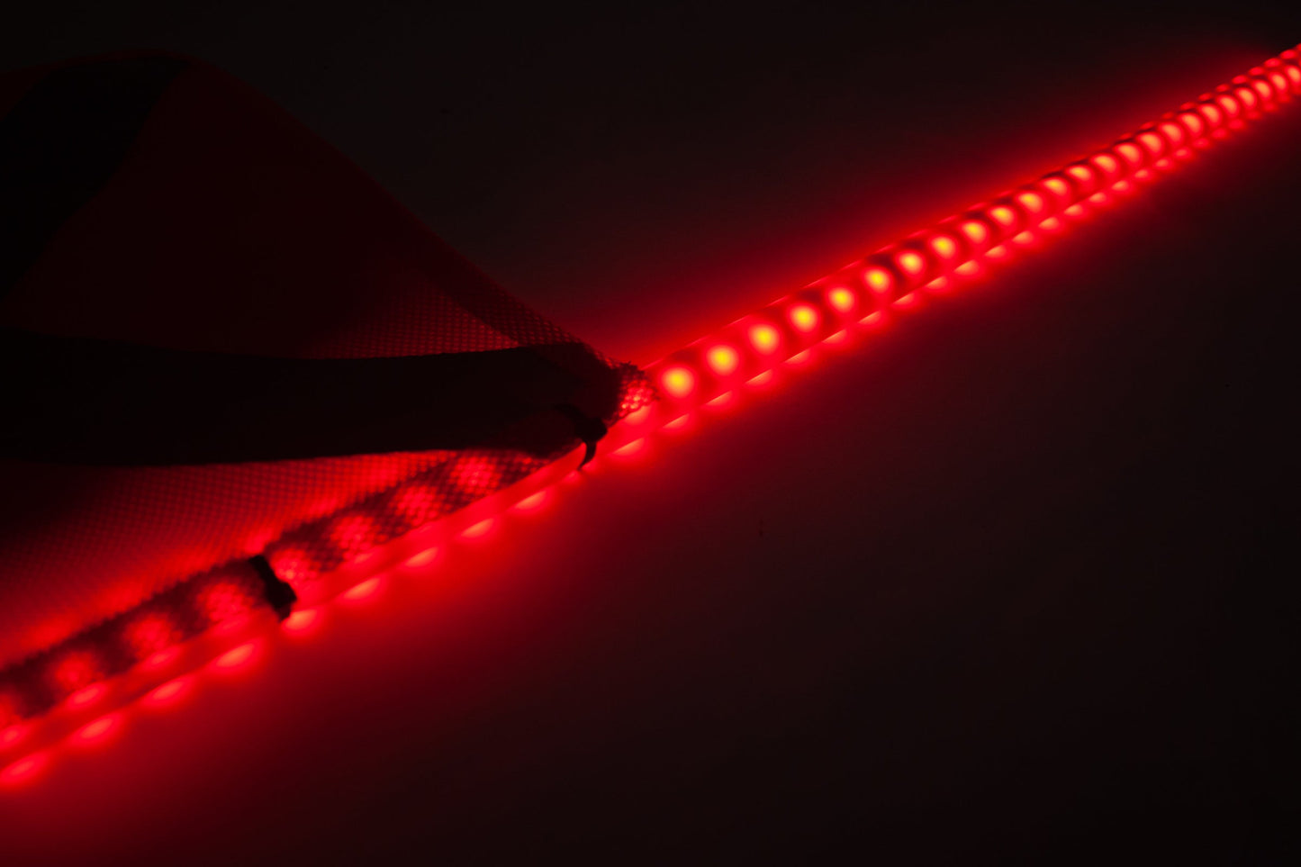 LED whip fully illuminated, showcasing its bright and colorful lighting designed to improve the visibility and safety of off-road vehicles, particularly in low-light conditions.